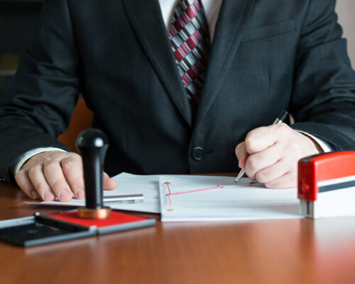 Notary Public in his office signing a contract